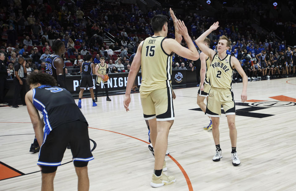 Purdue guard Fletcher Loyer, right, and center Zach Edey celebrate the team's win over Duke in an NCAA college basketball game in the Phil Knight Legacy Championship in Portland, Ore., Sunday, Nov. 27, 2022. (AP Photo/Craig Mitchelldyer)