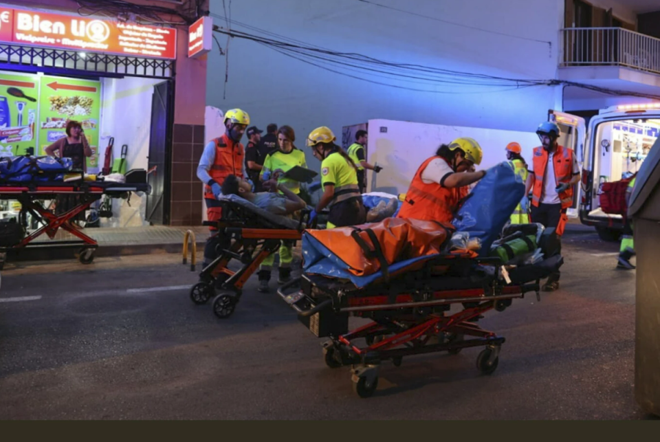 Injured people being taken from the scene on stretchers (Isaaz Buj/Europa Press via AP)