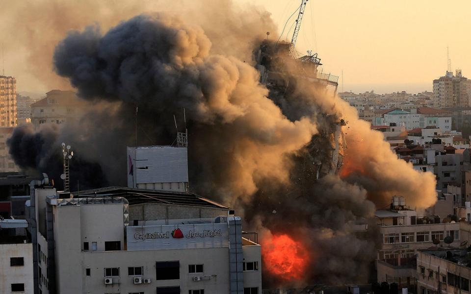 Smoke billows from a tower block after an Israeli air strike - AFP