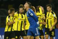 Football Soccer - Borussia Dortmund v SC Freiburg - German Bundesliga - Signal Iduna Park, Dortmund, Germany - 23/09/16 Lukasz Piszczek and team of Borussia Dortmund celebrate goal as SC Freiburg goal keeper Alexander Schwolow reacts. RUTERS/Thilo Schmuelgen