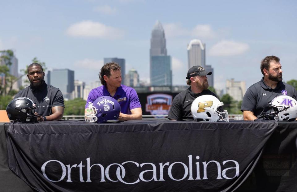 Hough’s coach DeShawn Baker, from left, Northwestern’s coach Page Wofford, Providence’s coach Weslee Ward and Ardrey Kell’s coach Greg Jachym, are announced as teams for the Charlotte Kickoff Classic at Memorial Stadium in Charlotte, N.C., on Tuesday, May 7, 2024.