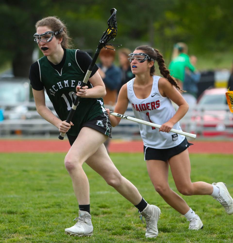 Archmere's Lucy Oliver (left) is pursued by Ursuline's Julianna Lenz in the Auks' 13-11 win in a visit to Serviam Field, Friday, May 5, 2023.