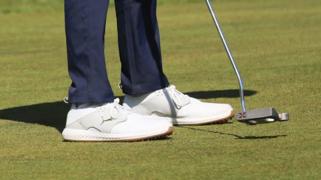 Puma Ignite Caged Crafted Golf Shoes, man wearing puma golf shoes, putting with golf shoes on putting green