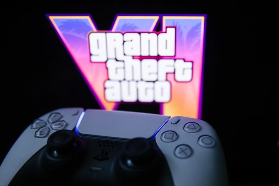 GTA VI logo from the trailer displayed on a laptop screen and PlayStation DualSense controller are seen in this illustration photo taken in Krakow, Poland on December 5, 2023. (Photo by Jakub Porzycki/NurPhoto via Getty Images)