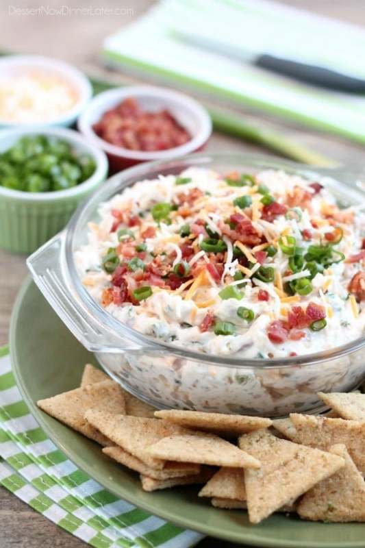 <p>Dessert Now Dinner Later</p><p>A loaded baked potato inspired this chip dip full of bacon, cheese, green onions and ranch dressing mix. A delicious party dip or game day appetizer. </p><p><a href="https://www.dessertnowdinnerlater.com/loaded-ranch-dip/" rel="nofollow noopener" target="_blank" data-ylk="slk:Get the Recipe;elm:context_link;itc:0;sec:content-canvas" class="link ">Get the Recipe</a></p>