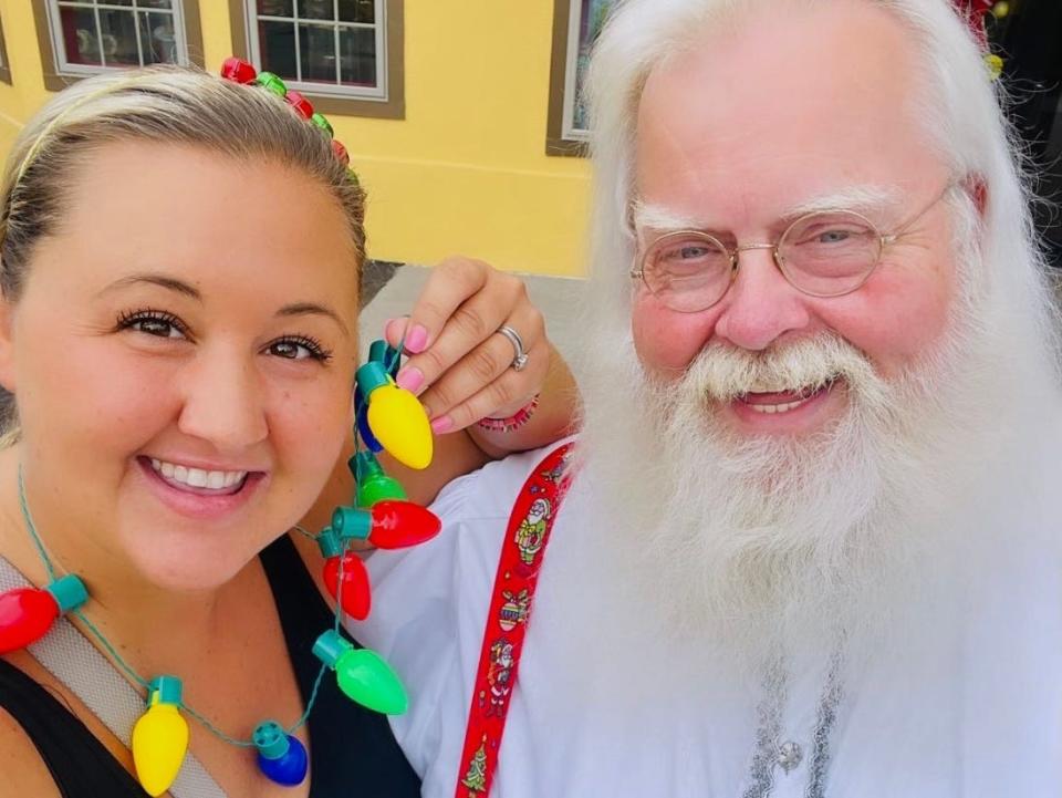 carly posing for a photo with santa at holiday world theme park