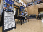 Johns Hopkins workers at Goldfarb Gymnasium prepare for a first-round game at the men's Division III NCAA college basketball tournament, between Worcester Polytechnic Institute and Yeshiva University, Friday, March 6, 2020, in Baltimore. The university held the tournament without spectators after cases of COVID-19 were confirmed in Maryland. (AP Photo/Terrance Williams)