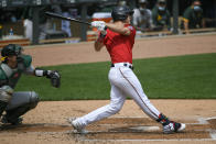 Minnesota Twins Max Kepler hits a three-run home run as Oakland Athletics catcher Sean Murphy looks on during the second inning of a baseball game, Sunday, May 16, 2021, in Minneapolis. (AP Photo/Craig Lassig)