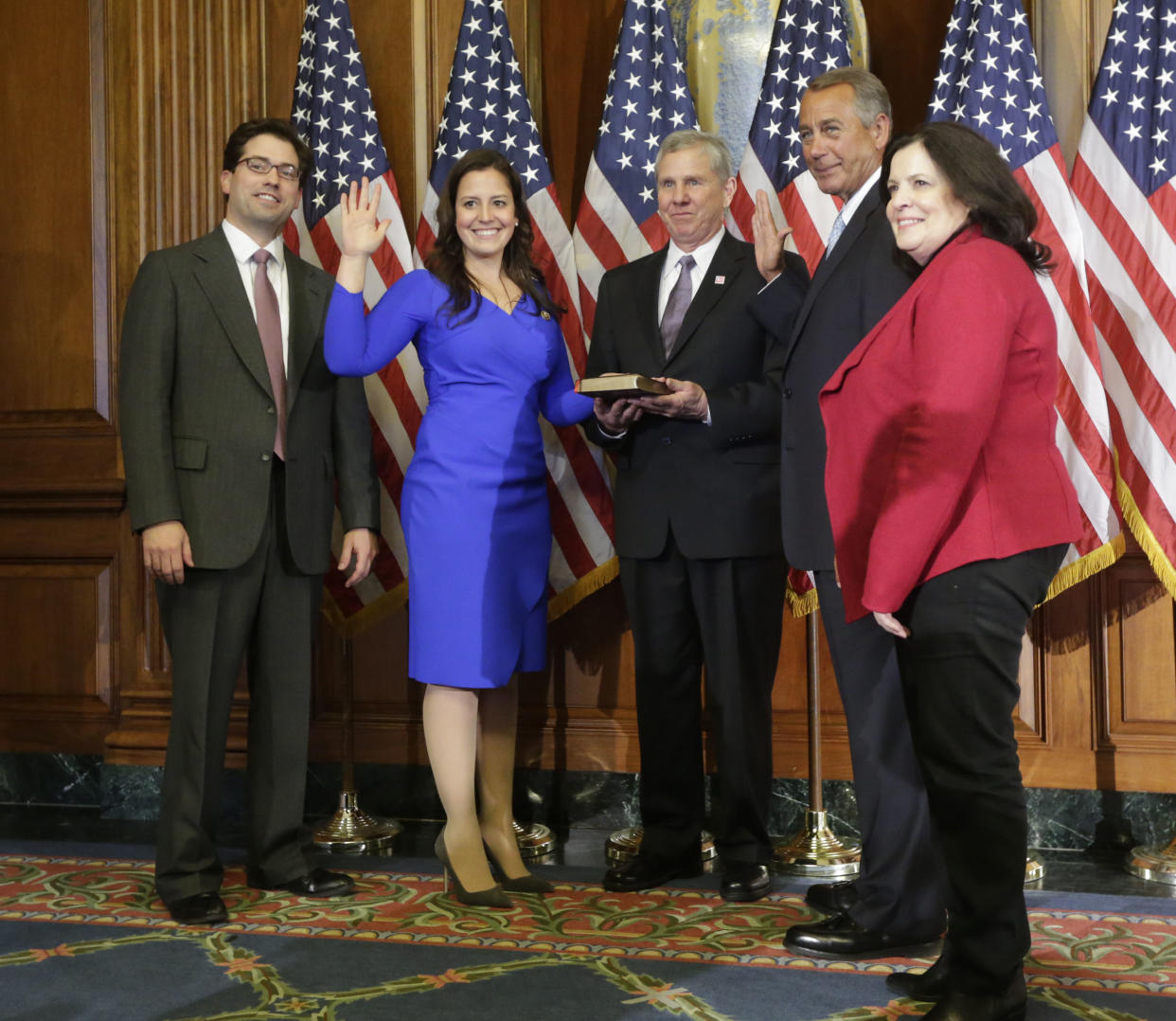House Speaker John Boehner of Ohio administers the House oath to Rep. Elise Stefanik, R-NY., during a ceremonial re-enactment swearing-in ceremony, Tuesday, Jan. 6, 2015, in the Rayburn Room on Capitol Hill in Washington. From left are, Stefanik's brother Matt, and their parents Ken and Melaine Stefanik. (Photo: Pablo Martinez Monsivais/AP)  