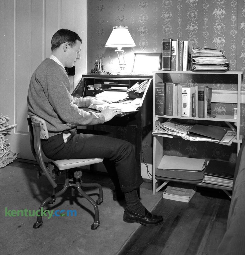 Sen. Mitch McConnell, in his third year in the College of Law at the University of Kentucky, in his Lexington apartment, January, 1967. McConnell shared a three-room apartment with Dan White, a candidate for a doctorate in English, on the second floor of a six-unit building at 337 South Mill St. The photo ran with a story on how their apartment building previously had a different front entrance when it was a house because it had faced a street that no longer existed. The story said McConnell was “chief cook” of the apartment he shared with White and that they met as eighth-graders at Manuel High School in Louisville. Both said an apartment in a more modern building might be easier to clean. “But then we don’t do much,” they admitted. “And this is the kind of home I’d like to own,” McConnell said. Their apartment was once the master bedroom for the house, which was built in 1816. The caption published with this photo said his desk is “like Linus’ blanket - it goes where he goes.” The books on the shelf next McConnell’s desk include “The Family and the Law,” “With Kennedy,” “The Making of the President, 1964,” Humor from Harper’s,” “Black’s Law Dictionary”, “Joy of Cooking,” The Anatomy of Liberty” and “Labor Relations and the Law.” McConnell, who was President of the student Bar Association, graduated with his law degree later that year. Published Sunday, Jan. 29, 1967 in the Sunday Herald-Leader. Herald-Leader file photo