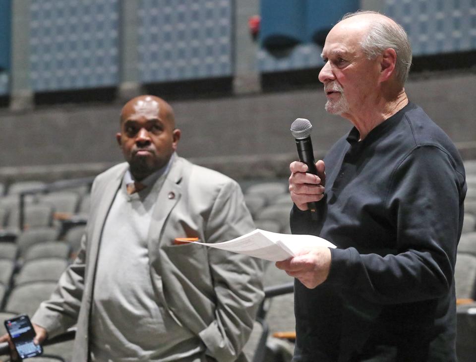 Kemp Boyd, chairman of the Akron Citizens' Police Oversight Board, listens to Bob Hoch, former Ward 6 Akron council member, ask a question of Anthony Finnell, the board's pick for the position of police auditor, Wednesday during a town hall event.