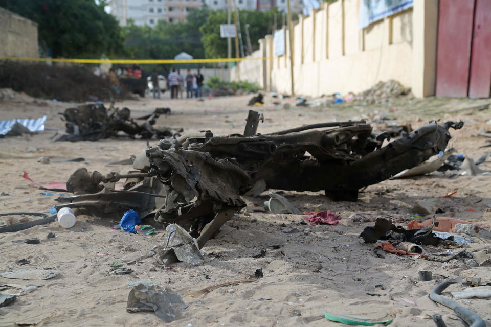 <p>A destroyed car is seen at the site after bomb-laden vehicle attack by Al-Shabaab militants to a restaurant in Mogadishu, Somalia on June 15, 2017. (Photo: Saadaq Maxamed/Anadolu Agency/Getty Images) </p>