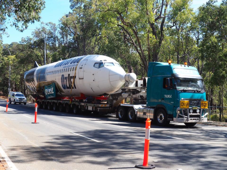 The plane being transported to the air park.