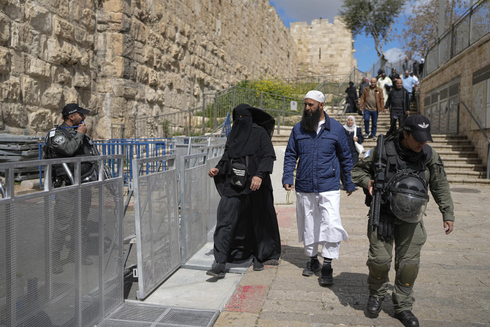Israeli security forces stand guard while Muslim worshippers make their way to the Al-Aqsa Mosque compound during the Muslim holy month of Ramadan in Jerusalem's Old City, Friday, March 15, 2024. (AP Photo/Ohad Zwigenberg)