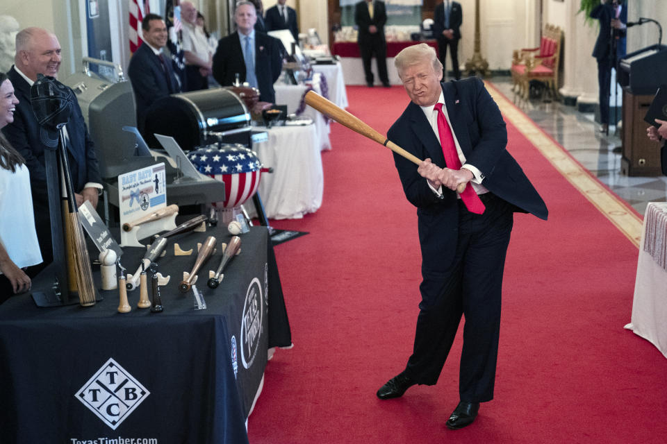 President Donald Trump swings a baseball bat during the Spirit of America Showcase at the White House, Thursday, July 2, 2020, in Washington. (AP Photo/Evan Vucci)