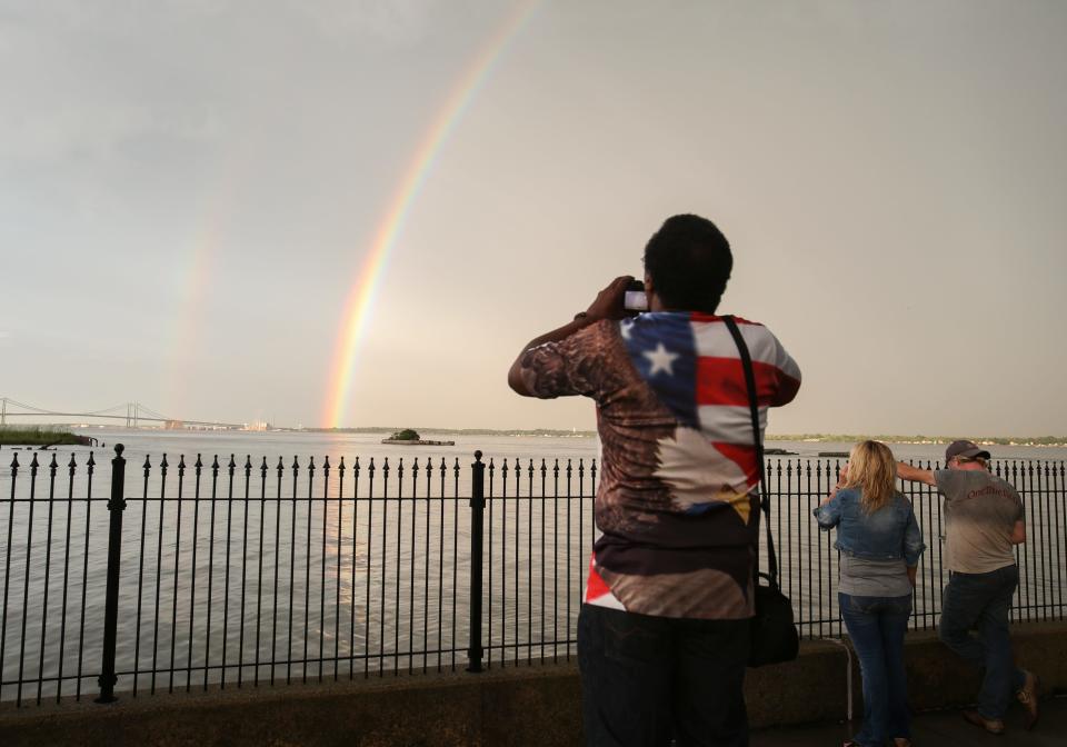 An intense full double rainbow broke out over clearing skies in the gap between thunderstorms at the end of daylight Friday. People take in the sight from New Castle's pier adjacent to Battery Park.