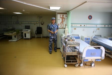 A member of the Chinese People Liberation Army Navy stands next to beds at the China's People's Liberation Army (PLA) Navy hospital ship Peace Ark, after its arrival at the port in La Guaira, Venezuela September 22, 2018. REUTERS/Manaure Quintero