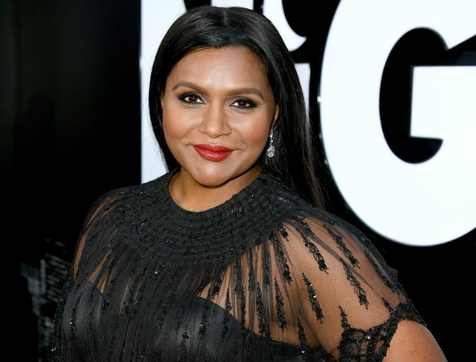 Mindy smiles in a black dress at an event