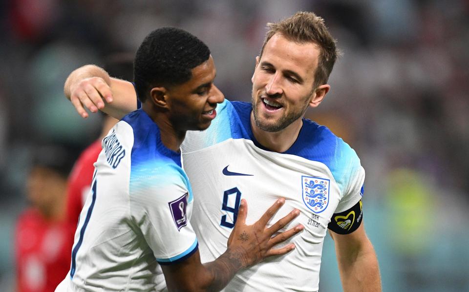 Marcus Rashford celebrates with Harry Kane of England after scoring their team's fifth goal