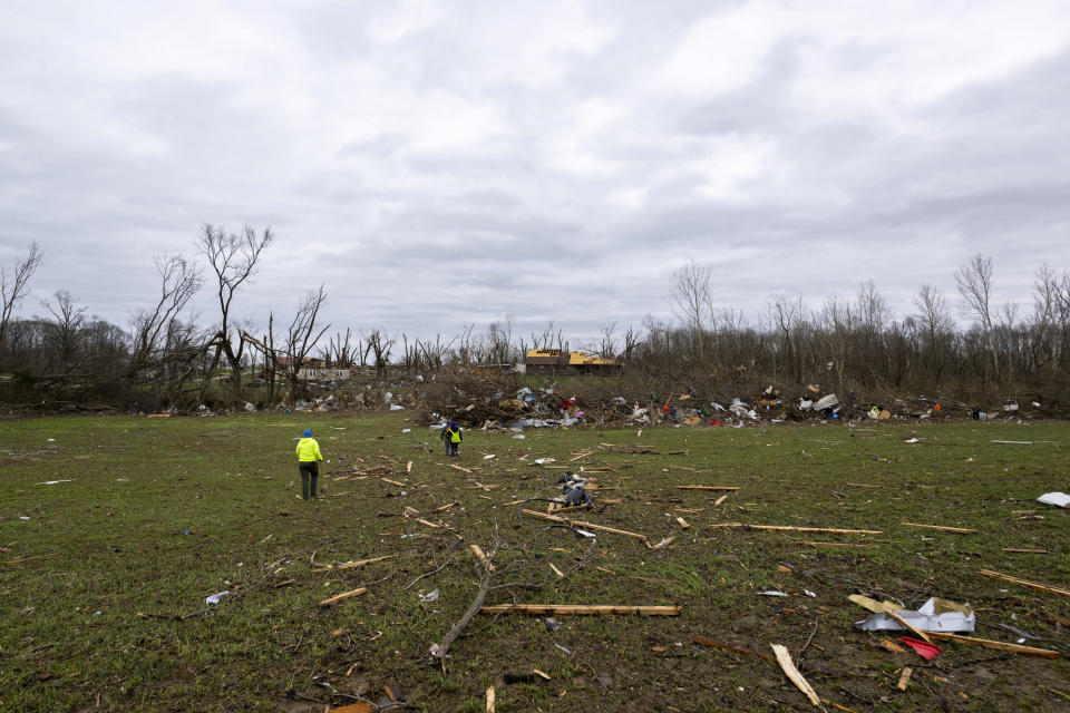 Volunteers comb through an area that was heavily damage by a tornado in Sullivan, Ind., Saturday, April 1, 2023, as search-and-rescue efforts continue. Storms that spawned possibly dozens of tornadoes have killed several people in the South and Midwest. (AP Photo/Doug McSchooler)