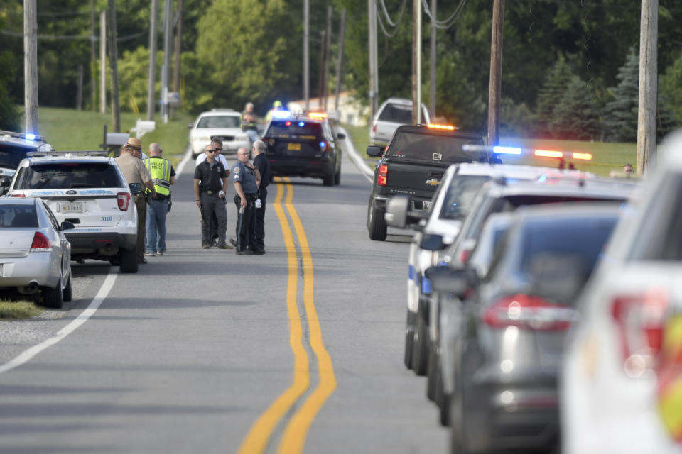 Police work near where a man opened fire at a business, killing three people before the suspect and a state trooper were wounded in a shootout, according to authorities, in Smithsburg, Md., Thursday, June 9, 2022. The Washington County (Md.) Sheriff's Office said in a news release that three victims were found dead at Columbia Machine Inc. and a fourth victim was critically injured. (AP Photo/Steve Ruark)