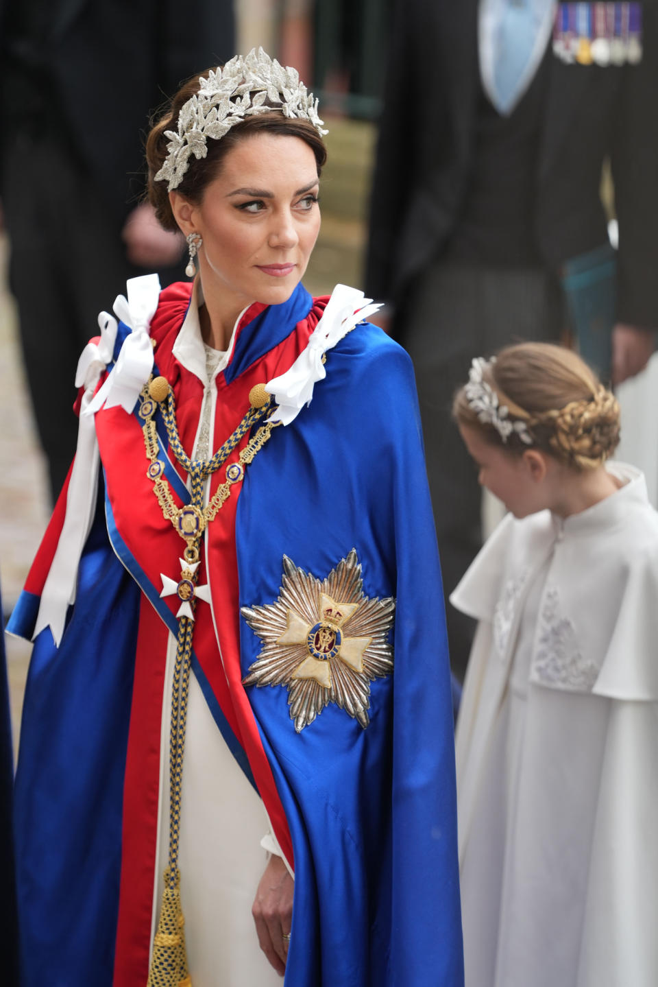 For the coronation of King Charles III and Queen Camilla, the newly crowned Princess of Wales arrived in an Alexander McQueen dress with a formal mantel overtop. Rather than a tiara, she wore a headpiece by milliner Jess Collett and Alexander McQueen paired with South Sea Pearl and Diamond earrings that belonged to Princess Diana.