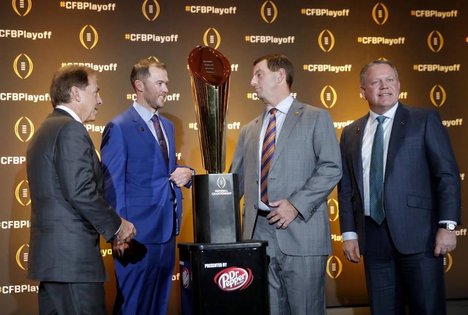 The coaches of the four teams in the College Football Playoff, from left, Alabama's Nick Saban, Oklahoma's Lincoln Riley, Clemson's Dabo Swinney and Notre Dame's Brian Kelly chat after a news conference Thursday, Dec. 6, 2018, in Atlanta. Alabama will face Oklahoma in the Orange Bowl and Clemson and Notre Dame will play in the Cotton Bowl. (AP Photo/John Bazemore)