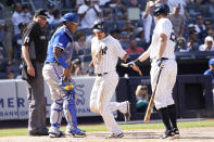 New York Yankees' Isiah Kiner-Falefa, center, celebrates with DJ LeMahieu, right, after scoring off an error by Kansas City Royals catcher Salvador Perez, second from left, during the sixth inning of a baseball game, Saturday, July 30, 2022, in New York. (AP Photo/Mary Altaffer)