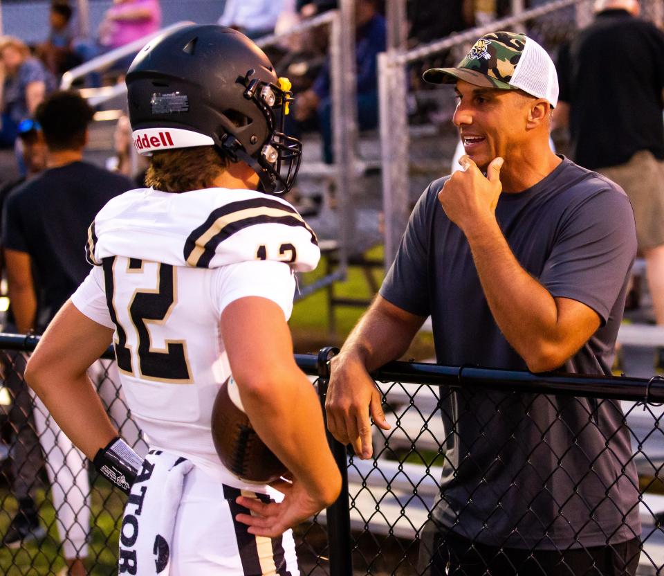 Former Gator quarterback and NFL quarterback Doug Johnson, right, talks with his son Trace Johnson before the start of the second half. The Bradford Tornadoes hosted the Buchholz Bobcats at Bradford High School in Starke, FL on Thursday, May 25, 2023. [Doug Engle/Gainesville Sun]