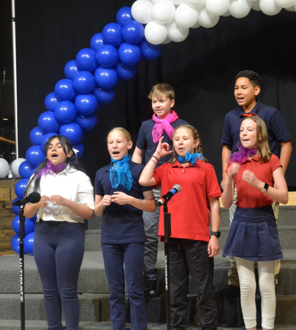 Fifth and sixth graders in the French dual-language immersion program at Axis International Academy in Fort Collins sing during a ceremony at the school on Monday to celebrate the school earning the Label of FrancEducation from the French Ministry of Education and Youth.
