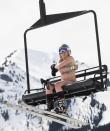 A skier braves the cold while riding a chairlift during the Bikini & Board Shorts Downhill at Crystal Mountain, a ski resort near Enumclaw, Washington April 19, 2014. Skiers and snowboarders competed for a chance to win one of four season's passes. REUTERS/David Ryder (UNITED STATES - Tags: SPORT SOCIETY)