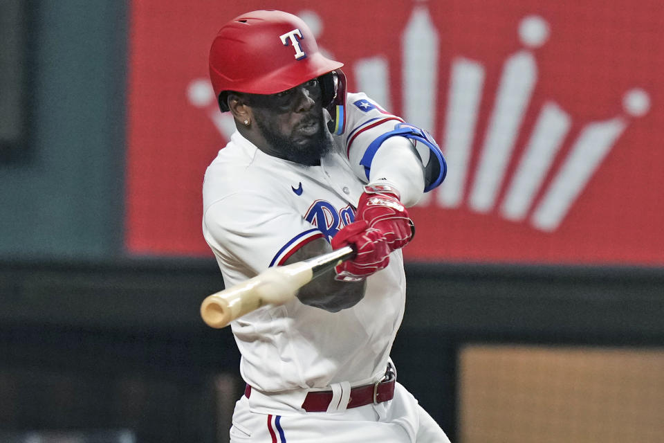 Texas Rangers Adolis Garcia hits a home run that also scored teammate Nathaniel Lowe during the eighth inning of a baseball game against the Detroit Tigers in Arlington, Texas, Tuesday, June 27, 2023. (AP Photo/LM Otero)