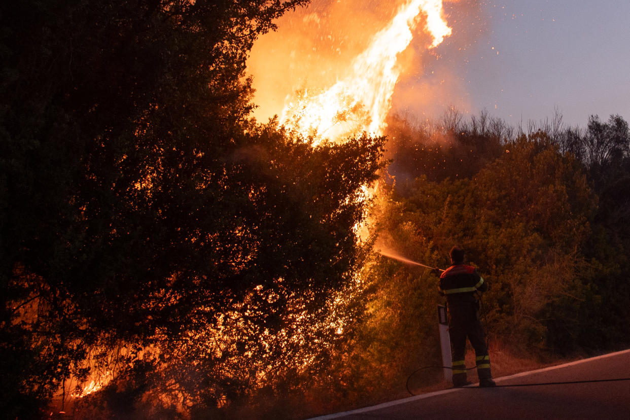 POSADA, ITALY - AUGUST 07: A wildfire burns in Posada in the province of Nuoro on August 07, 2023 in Posada, Italy. A number of homes and resorts in the area have been evacuated as strong mistral winds help fuel the flames, being tackled by firefighting and civil protection teams along with helicopters and Canadair aircraft. (Photo by Emanuele Perrone/Getty Images)