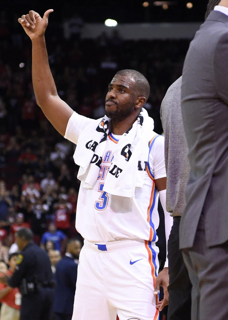 Oklahoma City Thunder guard Chris Paul acknowledges the crowd during a video tribute to his career with the Houston Rockets during the first half of an NBA basketball game against the Rockets, Monday, Oct. 28, 2019, in Houston. (AP Photo/Eric Christian Smith)