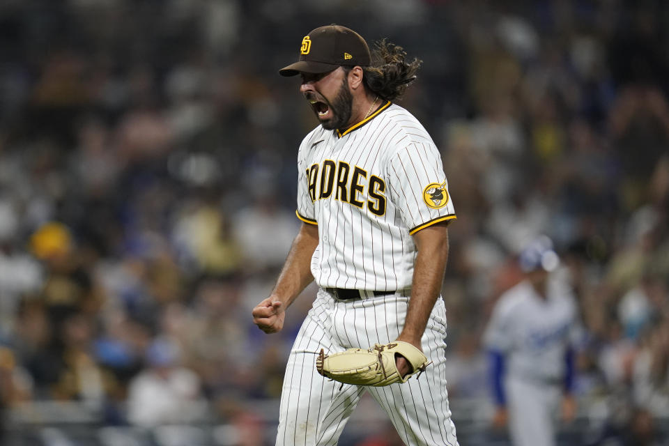 San Diego Padres relief pitcher Nabil Crismatt reacts after getting the third out during the thirteenth inning of a baseball game against the Los Angeles Dodgers, Wednesday, Aug. 25, 2021, in San Diego. (AP Photo/Gregory Bull)