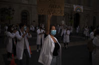 Medical residents take part in a protest against their working conditions during a strike in Barcelona, Spain, Tuesday, Oct. 20, 2020. Regional authorities across Spain continue to tighten restrictions against a sharp resurgence of coronavirus infections that is bringing the country’s cumulative caseload close to one million infections, the highest tally in western Europe. (AP Photo/Emilio Morenatti)