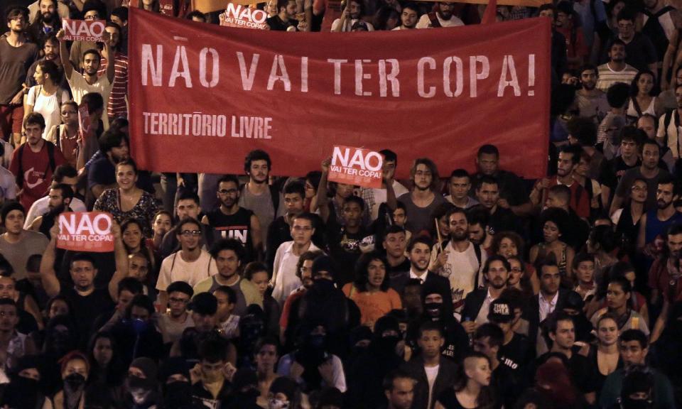 Demonstrators holding a banner that reads in Portuguese "There wont be a Cup", protest against money spent on the World Cup preparations in Sao Paulo, Brazil, Thursday, March 13, 2014. Brazilian Sports Minister Aldo Rebelo guaranteed "the World Cup in Brazil will be the safest" in history even though widespread demonstrations are expected across the country to protest against corruption, poor public services and the billions of dollars being spent on the World Cup and 2016 Olympics in Rio de Janeiro. (AP Photo/Andre Penner)