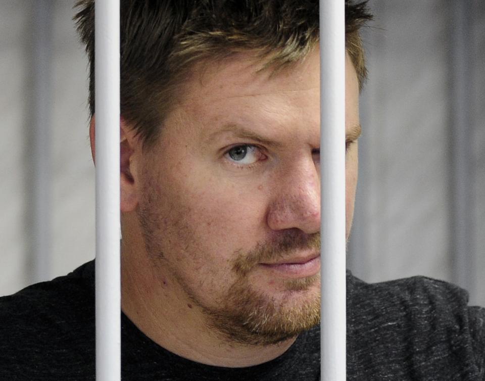 Greenpeace activist Anthony Perrett from Britain looks out from a defendants' box at a district court in Murmansk