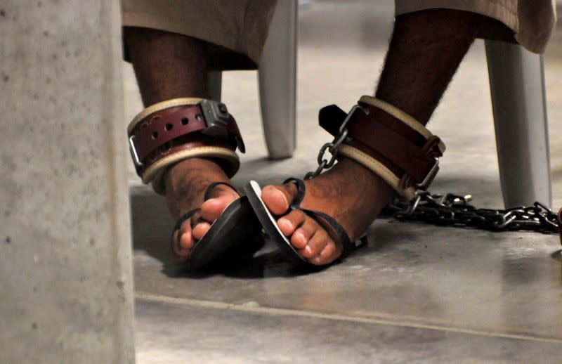 FILE PHOTO: A Guantanamo detainee's feet are shackled to the floor as he attends a "Life Skills" class at Guantanamo Bay U.S. Naval Base