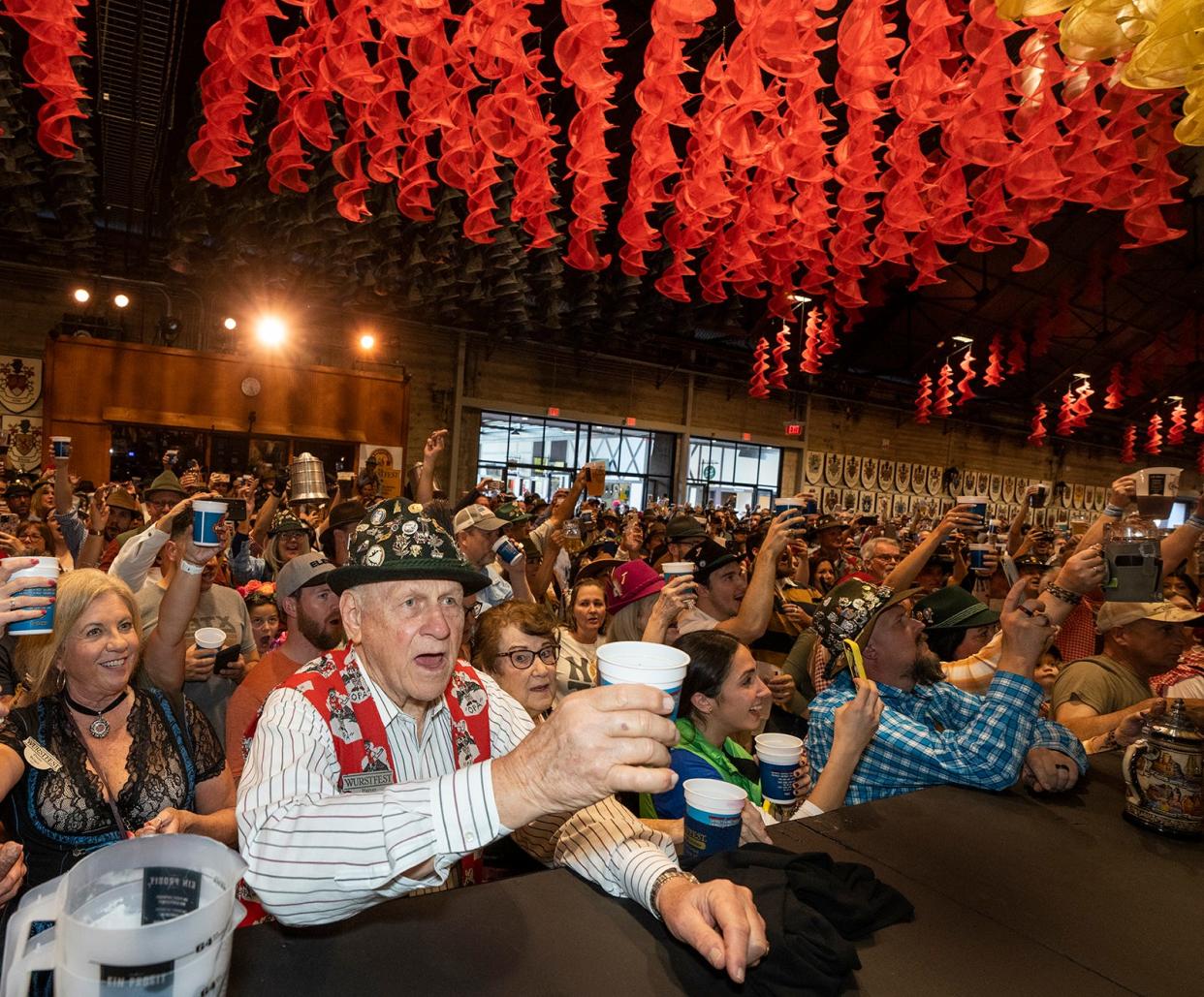 Festival attendees cheer as Wurstfest kicks off in New Braunfels on Friday, Nov. 3, 2023. The town was named after Braunfels, Prince Carl of Solms-Braunfels' ancestral castle on the Lahn River in the German state of Würtemberg.