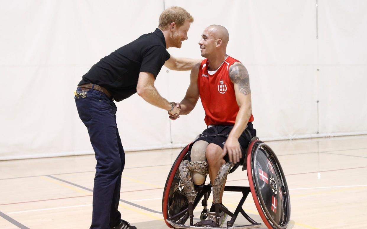 Prince Harry greets an athlete at the Toronto Pan Am Sports Centre ahead of the Invictus Games in Toronto - REUTERS