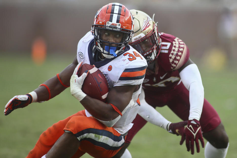 Syracuse running back Sean Tucker (34) makes a cut on Florida State defensive back Jammie Robinson (10) in the fourth quarter of an NCAA college football game, Saturday, Oct. 2, 2021, in Tallahassee, Fla. Florida State won 33-30. (AP Photo/Phil Sears)