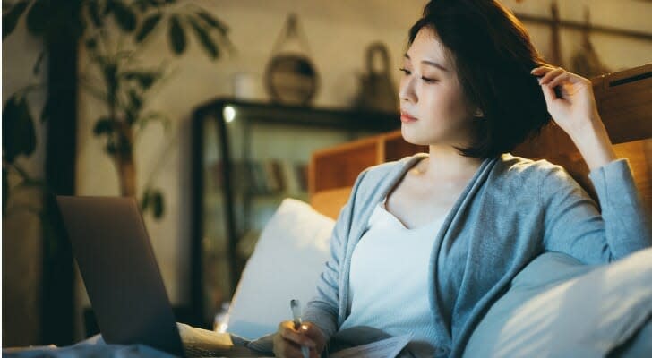 Young Asian woman checking her brokerage account