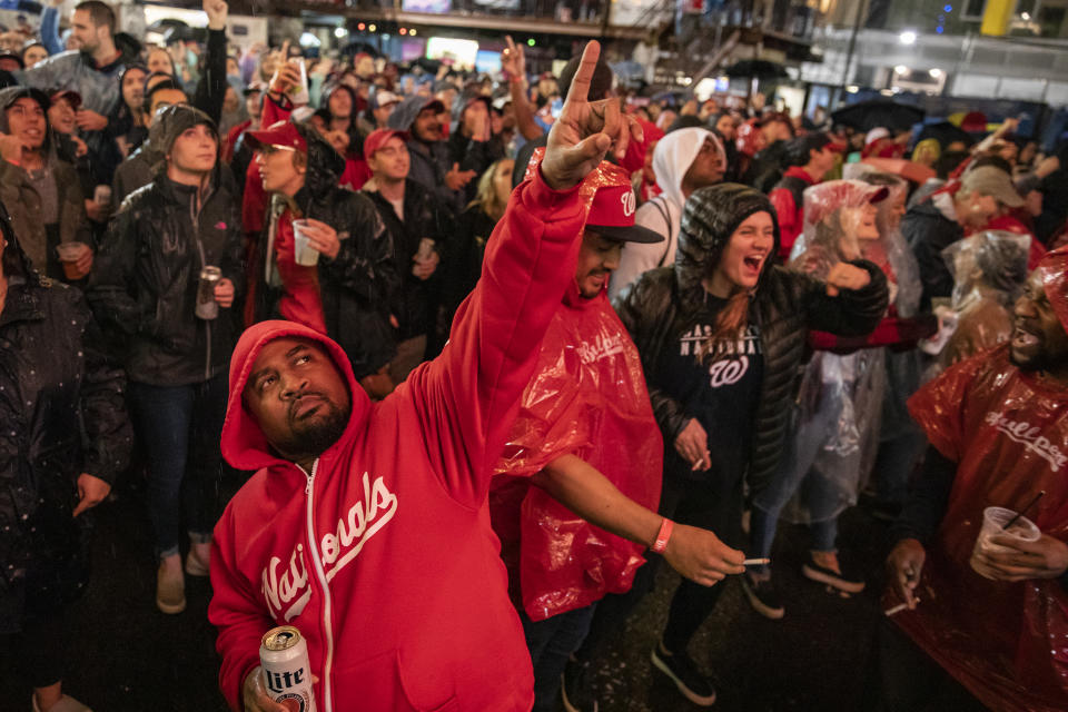 Fans braved the rain in and around Nationals Park for Game 7, and weren't pleased when Donald Trump showed up on the big screen. (Samuel Corum/Getty Images)