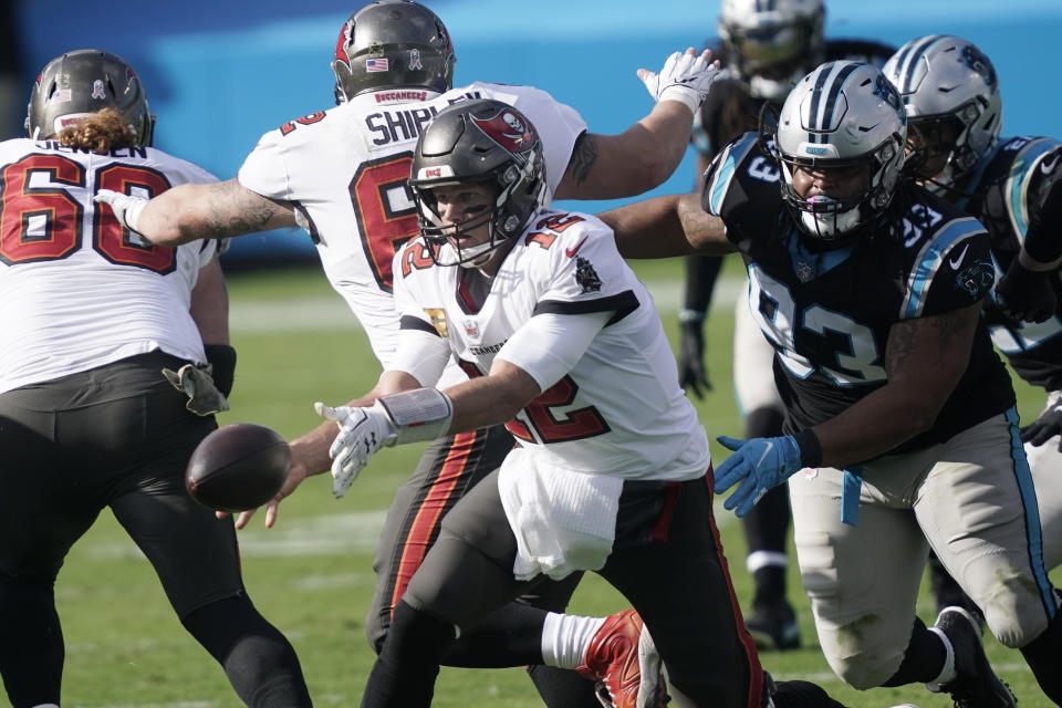 Tampa Bay Buccaneers quarterback Tom Brady (12) works as Carolina Panthers defensive tackle Bravvion Roy (93) defends during the first half of an NFL football game, Sunday, Nov. 15, 2020, in Charlotte , N.C. (AP Photo/Gerry Broome)