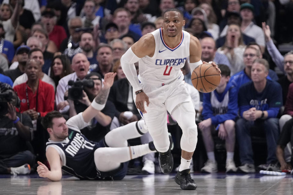 Los Angeles Clippers guard Russell Westbrook (0) comes away with a steal from Dallas Mavericks' Luka Doncic, left, during the first half of Game 2 of an NBA basketball first-round playoff series Friday, April 26, 2024, in Dallas. (AP Photo/Tony Gutierrez)