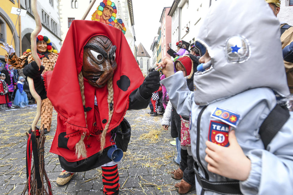 A group of fools dressed as witches attend a parade during the great fool's leap through the city centre of Konstanz, Germany, Sunday, Feb. 23, 2020. (Felix Kaestle/dpa via AP)