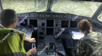 In this file image taken from a video distributed by Russian Investigative Committee, Investigative Committee employees works in a pilot cabin of a Russian Ural Airlines' A321 plane is seen after an emergency landing in a cornfield near Ramenskoye, outside Moscow, Russia, Thursday, Aug. 15, 2019. The Russian pilot was being hailed as a hero Thursday for safely landing his passenger jet in a corn field after it collided with a flock of gulls seconds after takeoff, causing both engines to malfunction. While dozens of people on the plane sought medical assistance, only one was hospitalized. (The Investigative Committee of the Russian Federation via AP) EDS NOTE: Watermark placed on image at source translated as InvestCom