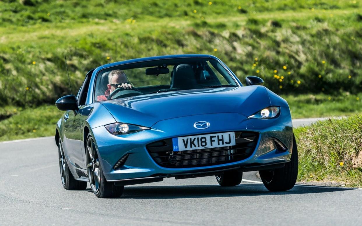 The Mazda MX-5 RF (shown here in 'Sport Black' special edition trim) has a retractable hard top roof 