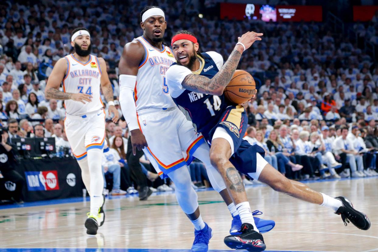 New Orleans forward Brandon Ingram (14) attempts to work past Oklahoma City guard Luguentz Dort (5) in the first quarter during game one of the NBA playoffs between the Oklahoma City Thunder and the New Orleans Pelicans at the Paycom Center in Oklahoma City, on Sunday, April 21, 2024.